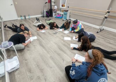 A group kids doing the home work on the floor